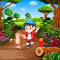 A boy with monkey in the rainforest