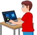 Boy Taking a Computer Based Test on His Laptop Royalty Free Stock Photo