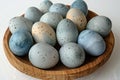 Breathtaking  easter eggs in a wooden bowl on a white background, top view Royalty Free Stock Photo