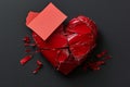 Broken heart with blank card on black background, top view,  Space for text Royalty Free Stock Photo