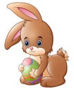 Cartoon Easter bunny carrying a basket full of eggs Royalty Free Stock Photo