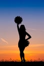 Cheerleader silhouette at sunset