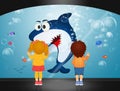 children watch the shark in the aquarium