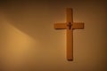 Illustration of a Christian cross with tiny cross on it hanging on brown wall