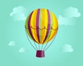 Illustration, colorful striped hot air balloon on the background of a landscape with clouds. Print, poster Royalty Free Stock Photo