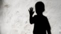 Illustration concept depicting the shadow of a child with a raised hand, symbolizing child abuse Royalty Free Stock Photo