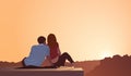 Illustration of a couple sitting on a cliff and looking at the sunset Royalty Free Stock Photo