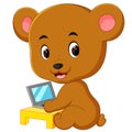 Cute bear using laptop computer