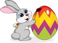 Cute rabbit painting an egg
