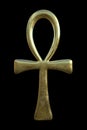 Golden ankh symbol on black background