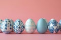 Depicting a row of easter eggs with blue and white patterns on the side, pink background, minimalist style, flat lay composit Royalty Free Stock Photo