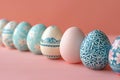Depicting a row of easter eggs with blue and white patterns on the side, pink background, minimalist style, flat lay composit Royalty Free Stock Photo