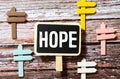 Illustration depicting a set of cut out printed letters arranged to form the word hope.