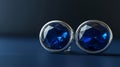 This illustration depicts a pair of silver or chrome cufflinks with blue gems set against a dark backdrop. Royalty Free Stock Photo