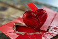Digital image of  broken red heart with a red paper on top of it Royalty Free Stock Photo
