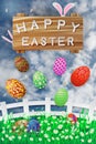 Illustration of easter day with an egg on green grass blooming flower and blue sky white fence ,with word on wood broad ,spring fe Royalty Free Stock Photo
