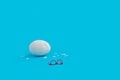 Illustration of an Easter egg one with cracks and broken eggshells and glasses on a blue background Royalty Free Stock Photo