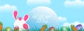 Illustration of the Easter poster and the banner with rabbits and beautifully painted eggs on the grass in the background of the Royalty Free Stock Photo