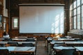 Elegant  a large, blank white projector screen was set up in an empty university classroom with desks and chairs arranged nea Royalty Free Stock Photo