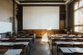 Elegant  a large, blank white projector screen was set up in an empty university classroom with desks and chairs arranged nea Royalty Free Stock Photo