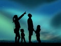Family looking aurora borealis