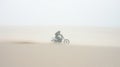 A fast military motorcycle riding through desert dunes Royalty Free Stock Photo