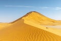 Featuring a  panoramic view of the sahara desert, with endless dunes stretching as far up into an open sky. the sand is golden an Royalty Free Stock Photo