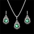 filigree silver jewelry set pendant on a chain and earrings with precious stones Royalty Free Stock Photo