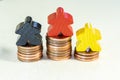 Illustration of Financial success with wooden game figures and coins Royalty Free Stock Photo