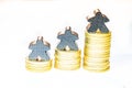 Illustration of growth with piles of ten cent coins and wooden meeples on white background Royalty Free Stock Photo