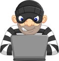 Hacker Thief in mask stealing personal information from computer