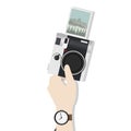 Illustration of hand holding digital camera with photograph clicked