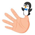 Hand wearing a cute penguin finger puppet on thumb Royalty Free Stock Photo