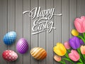 Happy Easter colorful egg with tulips flower beautifully above wooden gray background