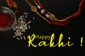 Illustration of Happy Rakhi with rakhi threads and rice on black background Royalty Free Stock Photo