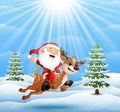 Happy santa claus riding a reindeer on snow downhill Royalty Free Stock Photo
