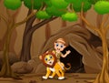 Happy zookeeper boy and lion in front the cave