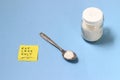 Illustration for healthy life style, salt at tea spoon, shaker, with yellow sticky paper note with text eat less salt, at blue bac