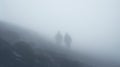 Hikers at distance during a strong blizzard