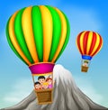 Hot air balloons flying with happy kids and mountain scene