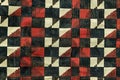 A houndstooth pattern in black, white and red colors. the fabric has an intricate design with small squares arranged to creat Royalty Free Stock Photo
