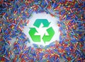 Illustration of hundreds of colorful batteries and in the middle the green recycle symbol