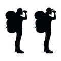 Isolated silhouette of a hiker girl looking through binoculars