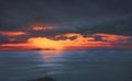 Illustration of landscape with dark cloudy sunset sky over the sea