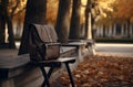 Leather satchel on a bench in autumn, back to school theme