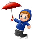 Little boy with red umbrella jumping Royalty Free Stock Photo