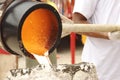 Illustration of molten metal being poured from a foundry crucible statue