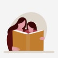 Mother helps her daughter to read a book Royalty Free Stock Photo