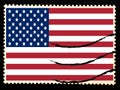 Illustration of national flag of United States of America on vintage postage stamp on black background. Old paper texture Royalty Free Stock Photo