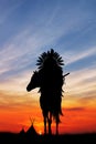 Native American Indian on horseback at sunset